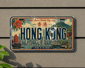 May include: A rectangular metal sign featuring a vintage-style illustration of the Hong Kong skyline. The text reads Asia's World City, Hong Kong, and Pearl of the Orient. It includes a red flower, a traditional junk boat, and a tram.