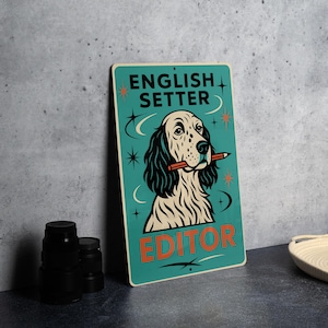 May include: A teal sign with the words "ENGLISH SETTER EDITOR" and a cartoon illustration of an English Setter dog holding a pencil in its mouth. The dog has black and white fur, and the sign has star and crescent moon accents.