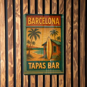 May include: A rectangular wooden sign with the words "BARCELONA TAPAS BAR" in yellow and green. The sign features a beach scene with palm trees, a surfboard, and a small building. The sign is mounted on a wooden slatted wall.