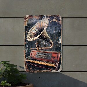 May include: A vintage-style metal sign featuring a black and gold gramophone with a red and brown piano keyboard. The sign has a distressed, aged look.