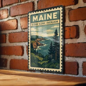 A vintage-style metal sign with the text "MAINE OCEAN SCENIC OVERLOOK" is displayed on a brick wall, depicting a scenic coastal landscape.