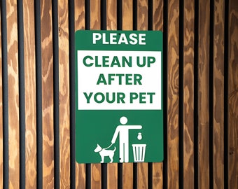 May include: Green sign with white text that reads "PLEASE CLEAN UP AFTER YOUR PET". A white silhouette of a person walking a dog and throwing a bag of waste into a bin is below the text.