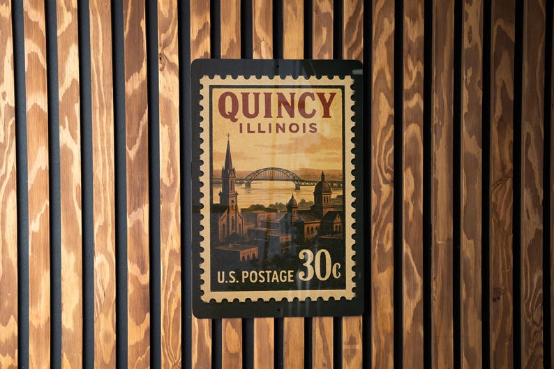 A vintage-style postage stamp from the United States, featuring an illustration of a cityscape and a bridge, hanging on a wooden wall.