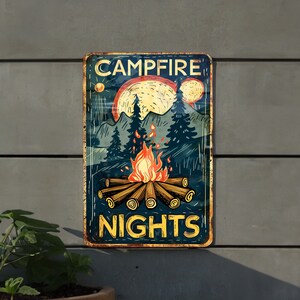 May include: A vintage-style metal sign with a campfire scene. The sign features a campfire with flames, logs, and a moon in the background. The text "CAMPFIRE NIGHTS" is printed in yellow letters.