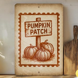 May include: A rectangular sign with a vintage aesthetic, featuring a brown border and the words "PUMPKIN PATCH" above three pumpkins. The sign is designed to look like a postage stamp.