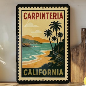 May include: Rectangular metal sign featuring a vintage travel poster design. The sign displays a beach scene with palm trees, ocean, and mountains. Text at the top reads "CARPINTERIA" and at the bottom "CALIFORNIA". The sign has a black border with a postage stamp edge.