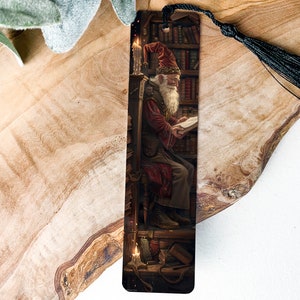 May include: A bookmark featuring a detailed illustration of a wizard reading a book in a library setting. The wizard is wearing a red robe and a pointed hat, and is surrounded by bookshelves filled with books. The bookmark is made of durable cardstock and has a black tassel.