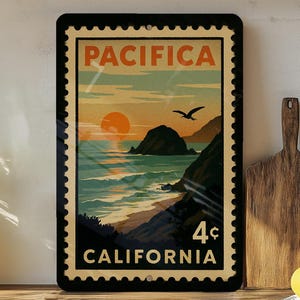 May include: A rectangular metal sign with a vintage postage stamp design featuring a coastal scene. The sign reads "PACIFICA" at the top and "CALIFORNIA" at the bottom, with a 4¢ value. The artwork depicts a sunset over the ocean with a flying bird.