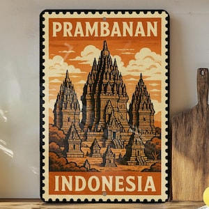 May include: A rectangular metal sign featuring a vintage-style illustration of the Prambanan temple complex in Indonesia. The sign has a postage stamp design with the words "PRAMBANAN" and "INDONESIA" in bold, orange lettering.