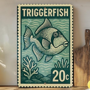 May include: A vintage-style metal sign featuring a detailed illustration of a triggerfish. The sign is in shades of teal and cream, with the word "TRIGGERFISH" at the top and a "20c" price tag. The design resembles a postage stamp.
