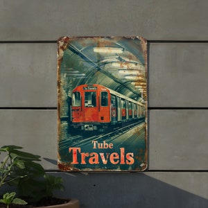 May include: A vintage metal sign featuring a red London Underground train emerging from a tunnel. The sign has a distressed, rusty appearance with the words "Tube Travels" in orange lettering. The background shows a tunnel with lights.