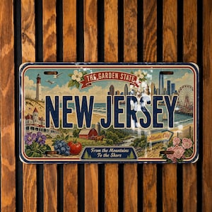 May include: A rectangular New Jersey license plate featuring a scenic illustration with a lighthouse, a city skyline, a Ferris wheel, and the text "THE GARDEN STATE", "NEW JERSEY", "Atlantic City", and "From the Mountains To the Shore".