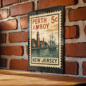 May include: Vintage-style metal sign featuring a nautical scene with a lighthouse, sailboat, and the text "Perth Amboy New Jersey." The sign has a postage stamp design with a 5-cent price and is mounted on a brick wall.