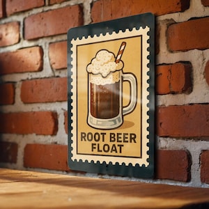 May include: A vintage-style metal sign featuring a root beer float illustration. The image shows a mug filled with dark liquid, topped with foamy cream and a striped straw. The words "ROOT BEER FLOAT" are printed below the mug.