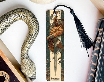 May include: A bookmark featuring a detailed illustration of a muscular figure holding a sword. The figure is depicted in a dynamic pose, with a green and gold background. The bookmark is labeled "Strength".
