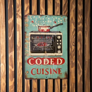 May include: A blue and red metal sign with a vintage design. The sign features an illustration of a stove with a pot on top and a dish in the oven. The text on the sign reads "CODED CUISINE".