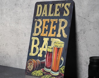 May include: A blue and gold metal sign with the text "DALE'S BEER BAR" and an illustration of two glasses of beer with hops.