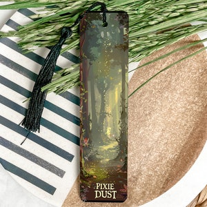 May include: A wooden bookmark with a forest scene and the text "Pixie Dust". The bookmark has a black tassel.