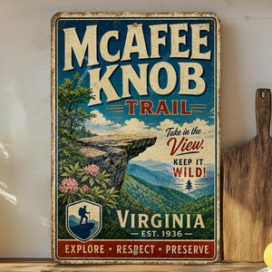 May include: Vintage metal sign featuring the McAfee Knob Trail in Virginia. The sign has a blue background with white and red text, and a scenic illustration of a mountain vista. The sign reads "Explore, Respect, Preserve."