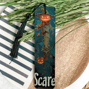 a bookmark with a scare on it sitting on a plate