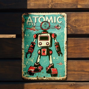 May include: A vintage-style metal sign with a blue background and a red and white robot illustration. The sign says "ATOMIC TOYS" at the top.