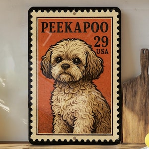 May include: A rectangular metal sign featuring a Peekapoo dog illustration, designed to resemble a vintage postage stamp. The sign has a red background with the text "PEEKAPOO 29 USA" and a black border. The dog is depicted with brown fur.