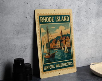 May include: A vintage-style metal sign featuring a nautical scene with sailboats on the water and buildings along the shore. The sign reads "Rhode Island Historic Waterfronts" in a teal and cream color scheme.