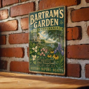 May include: A rectangular metal sign with the words "Bartram's Garden Pennsylvania" in white and teal lettering. The sign features a colorful illustration of a garden with flowers, a house, and a lake. The sign reads "America's Oldest Botanical Garden Est. 1728".