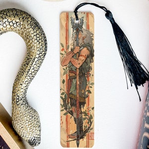 a snake, a bookmark, and some books on a table