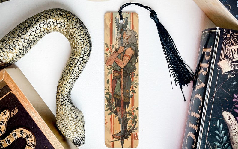 a snake, a bookmark, and some books on a table
