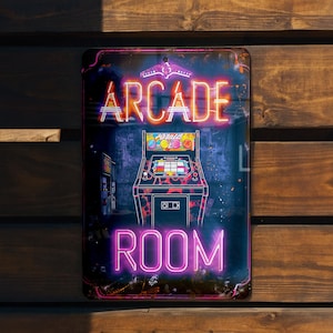 May include: A retro-style metal sign with a neon pink and orange "Arcade Room" sign. The sign features a pixelated arcade game with a black and white design.