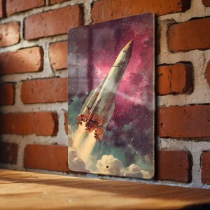 May include: Metal sign featuring a vintage-style illustration of a rocket ship blasting off into space. The artwork showcases a retro aesthetic with a vibrant galaxy backdrop, including shades of purple, red, and yellow. The rocket has a metallic finish.