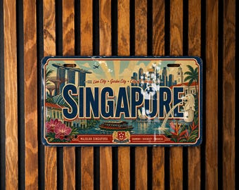 May include: A rectangular metal sign featuring a colorful illustration of Singapore landmarks, including the Merlion and Marina Bay Sands. The word SINGAPORE is printed in large blue letters across the center, with the text Lion City, Garden City, City of Tomorrow above it.