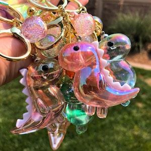 Iridescent Dinosaur Keychain – Cute Acrylic Dino Charm for Bags & Backpacks – Pink, Blue, Mocha, Green, White, Orange, Purple