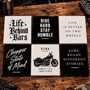 May include: A set of six square coasters featuring black and white designs with motorcycle-themed text and graphics, including phrases like Life Behind Bars, Ride Hard Stay Humble, Life Is Better On Two Wheels, Chopper State of Mind, and Dyna.