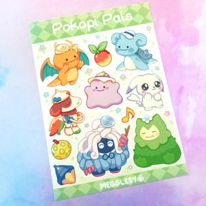 May include: A sticker sheet featuring colorful cartoon characters, including a dragon, a dog, and a blue turtle-like creature. The sheet has the text "Pokopi Pals" and "MEGGLESY" printed on it. The background is a light purple and white.