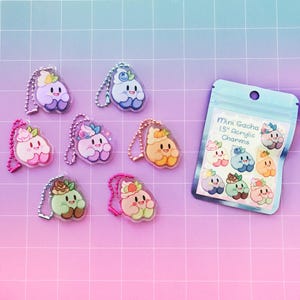 May include: A set of eight 1.5 inch acrylic charms featuring cute cartoon characters with different colors and designs. The charms are attached to keychains and come in a clear plastic bag with the text "Mini Gacha 1.5" Acrylic Charms".