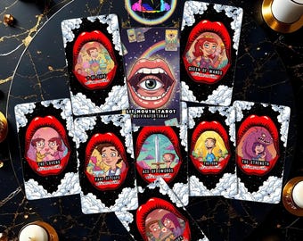 May include: A tarot card deck featuring colorful illustrations within red lips against a black background. The deck includes cards like "The Lovers," "Queen of Wands," and "Ace of Swords." The text "LIT MOUTH TAROT" is visible on one card.