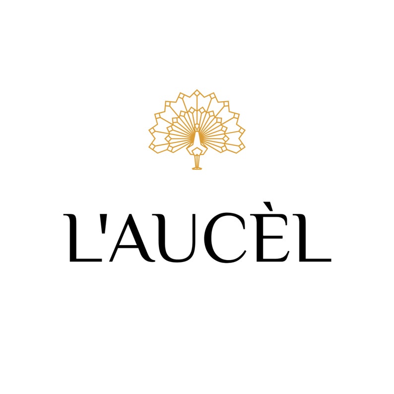 May include: A gold geometric peacock design with the text "L'AUCEL" below it.