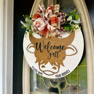 All season door hanger laser cut image long hair highland cow. Humorous "Please wipe your hooves"