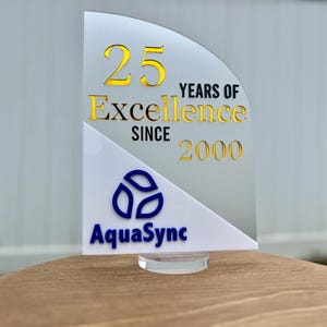 a sign celebrating 25 years of excellence since 2000, with the AquaSync logo prominently displayed.