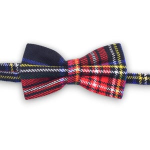 May include: A red, black, yellow, and blue plaid bow tie.
