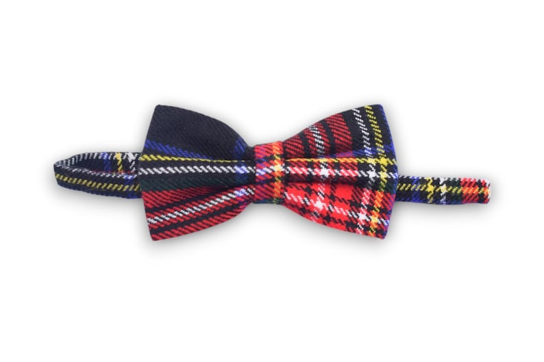 May include: A red, black, yellow, and blue plaid bow tie.