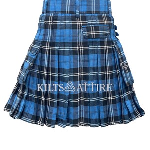 May include: A blue and black plaid kilt with two large cargo pockets on the sides. The kilt has a pleated design and is made of a woven fabric.