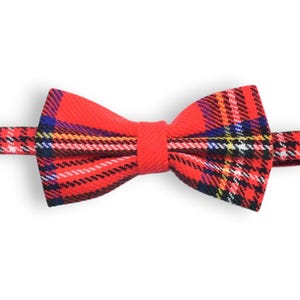 May include: Red and black plaid bow tie with a white and yellow plaid pattern.