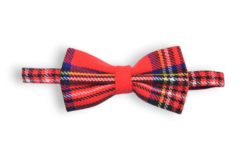 May include: Red and black plaid bow tie with a white and yellow plaid pattern.