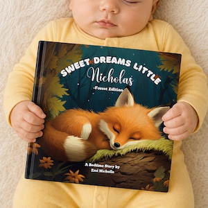 May include: A hardback children's book titled Sweet Dreams Little Nicholas - Forest Edition, featuring an illustration of a sleeping fox on a log. The cover includes the text Sweet Dreams Little Nicholas - Forest Edition and A Bedtime Story by Ersi Nicholls, set against a dark forest background with autumn leaves.