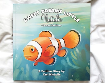 May include: A blue and green illustrated book cover with a cartoon orange and white clownfish. The title reads "Sweet Dreams Little Natalie - Ocean Edition -" and the text below the fish reads "A Bedtime Story by Ersi Nicholls".