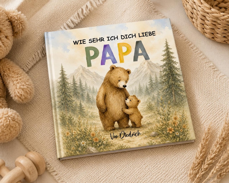 May include: A children's book with the title "WIE SEHR ICH DICH LIEBE PAPA" featuring a watercolor illustration of a bear and a cub in a forest setting. The book cover has a soft, pastel color palette.