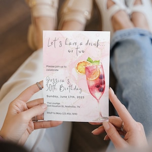 May include: Pink and gold birthday invitation with a watercolor illustration of a cocktail glass filled with fruit and berries. The text reads "Let's have a drink... or two. Please join us to celebrate Jessica's 30th Birthday. Sunday, June 17th, 2023. The Lounge, 314 Houston St, Nashville, TN. RSVP to Mary 123.456.7890"